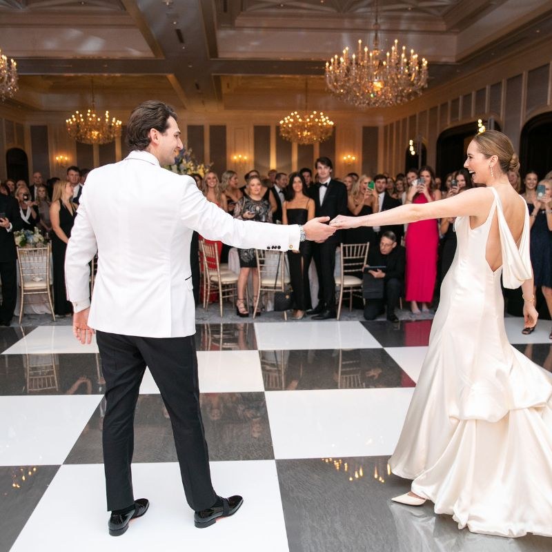Custom printed gold monogram dance floor with a live band playing at a Tulsa wedding reception
