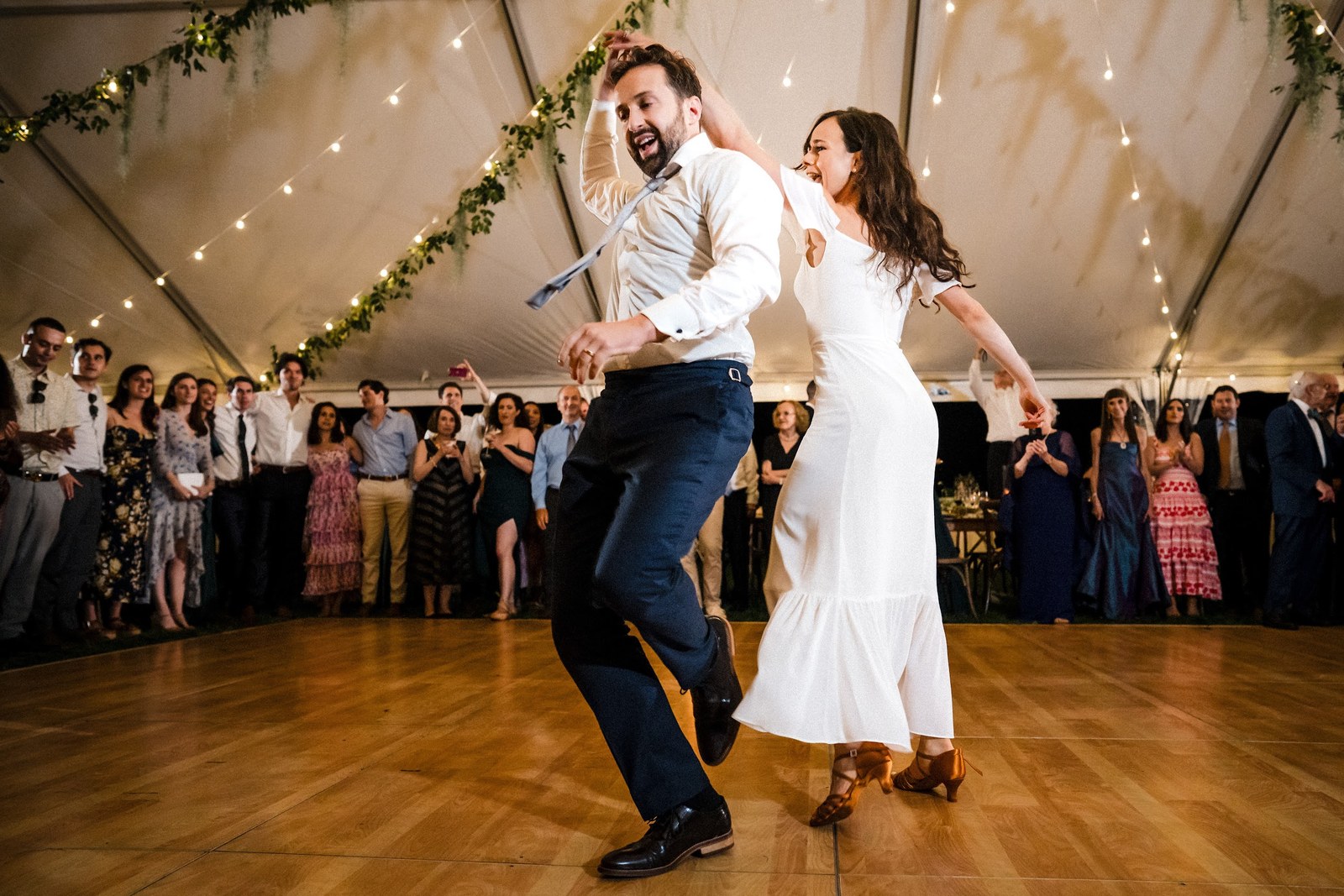 Bride and groom sharing a close first dance under a tent at a Tulsa wedding reception